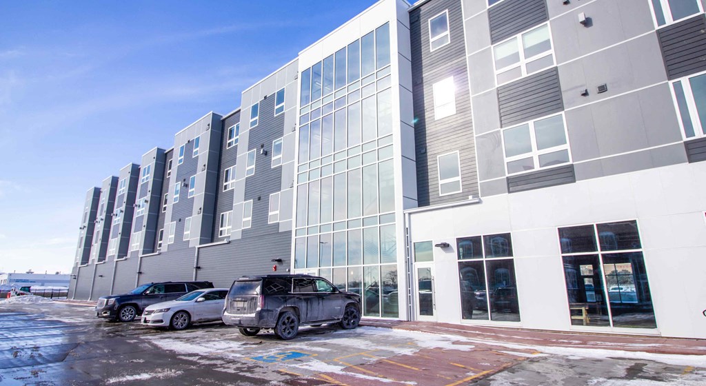 a new building with cars parked in front of it
