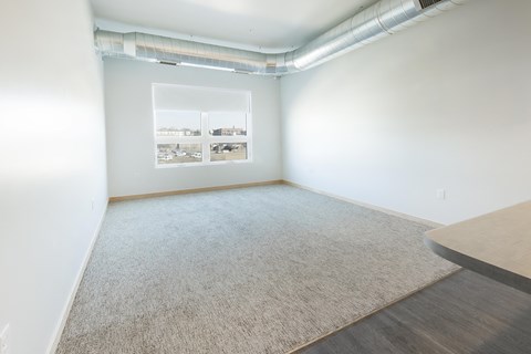 an empty room with white walls and a window