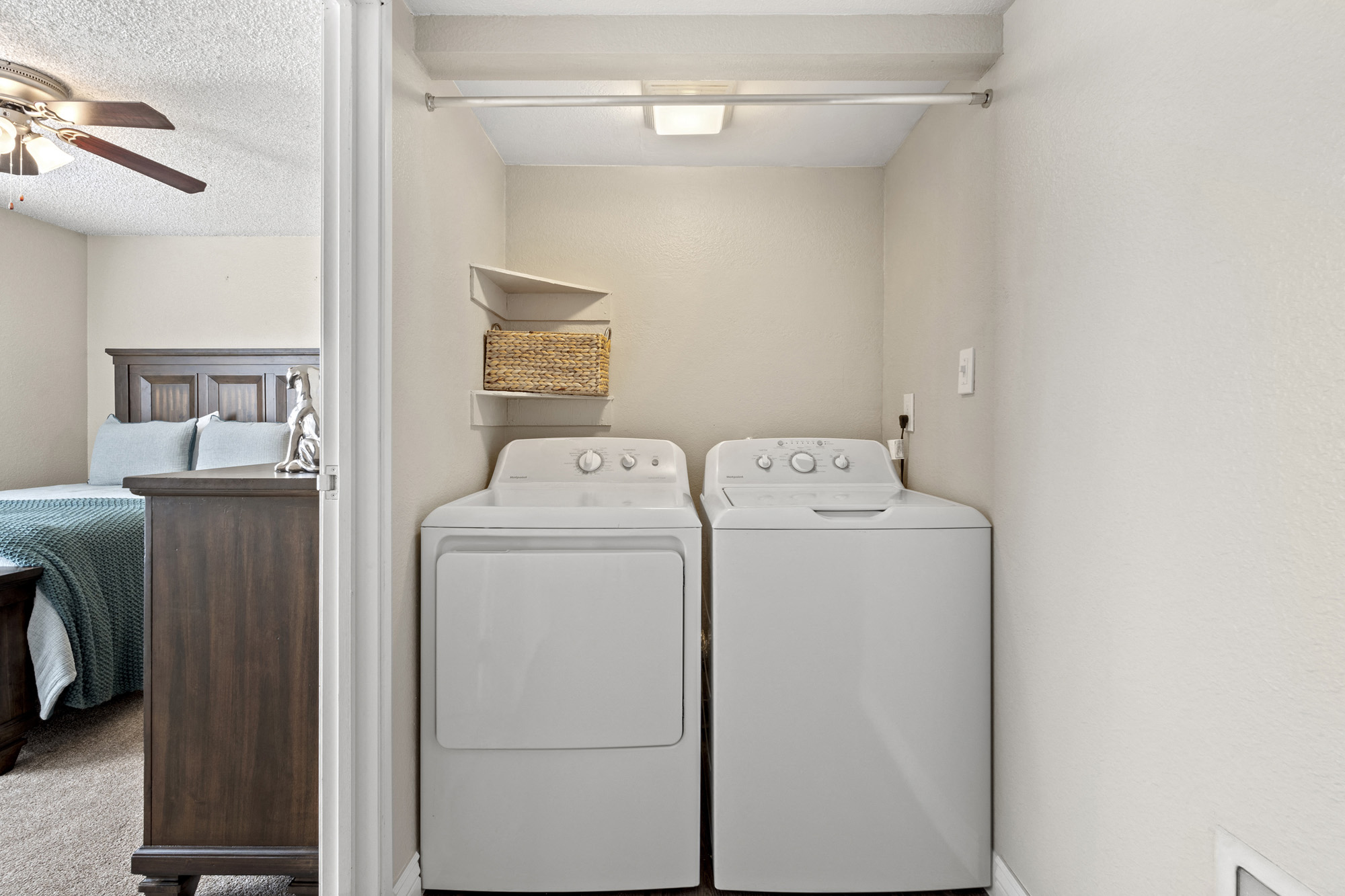 a washer and dryer in a room next to a bedroom