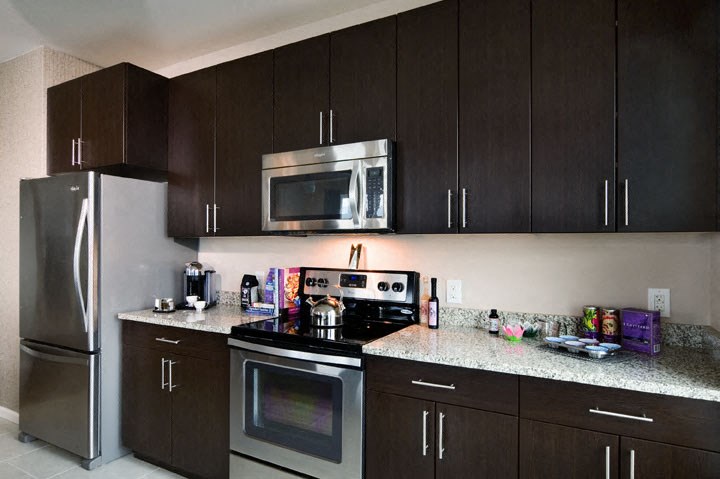 a kitchen with stainless steel appliances and granite counter tops