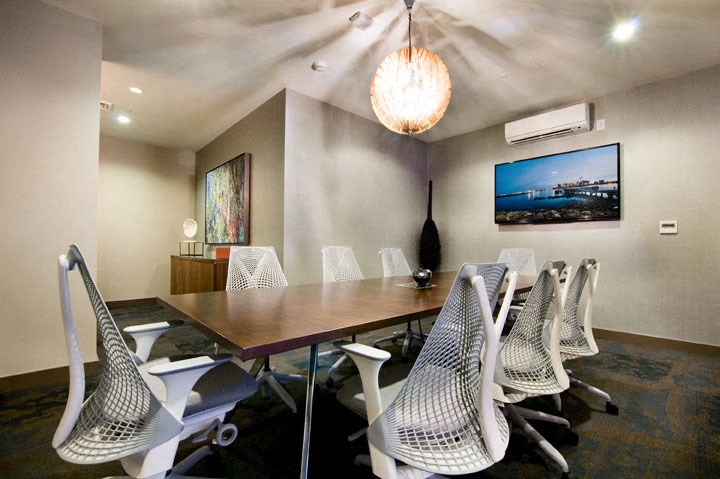 a conference room with a long wooden table and chairs