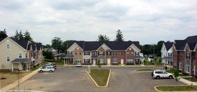 a street with cars parked in front of houses