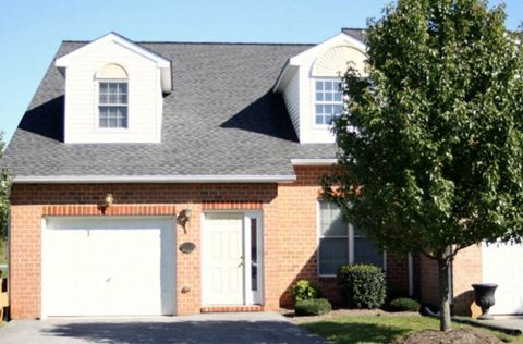 a brick house with a white garage door