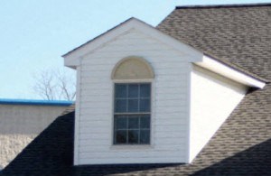 a large brick house with a white door and a garage