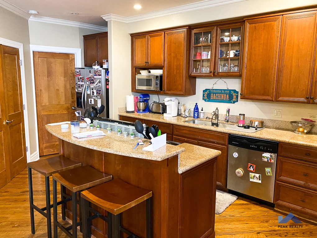 a kitchen with a large counter and some stools