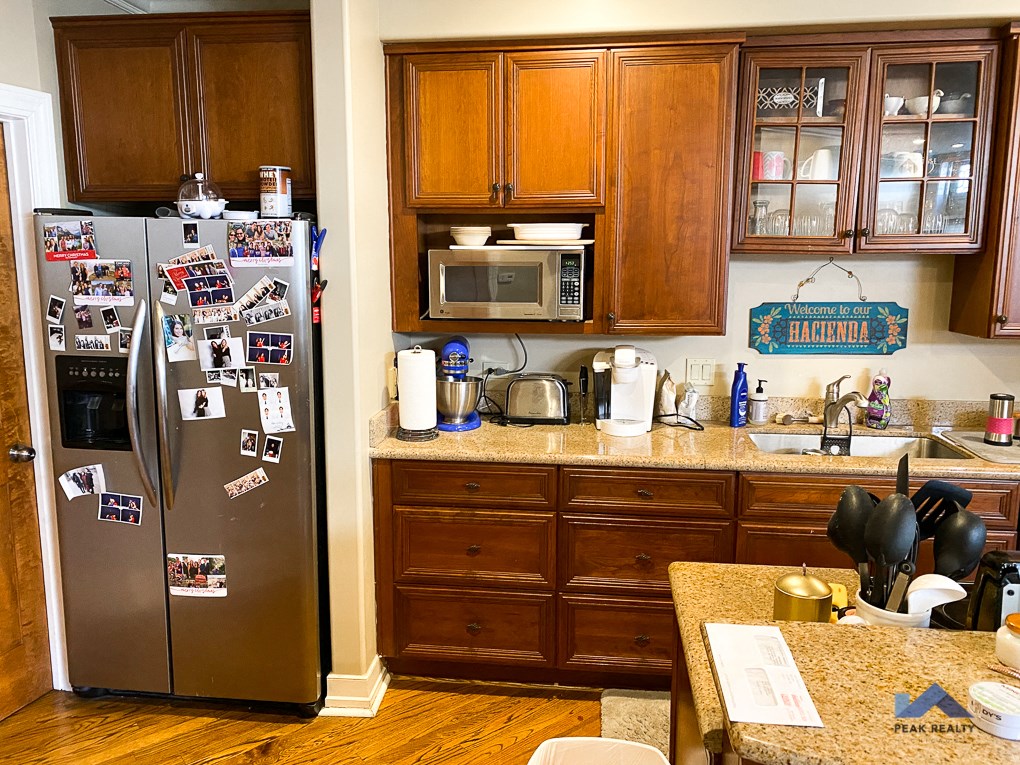 a kitchen with a stainless steel refrigerator and wooden cabinets