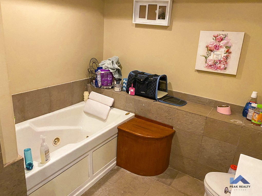 a bathroom with a tub and a sink and a toilet