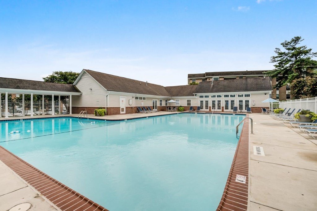 a large swimming pool with a building in the background