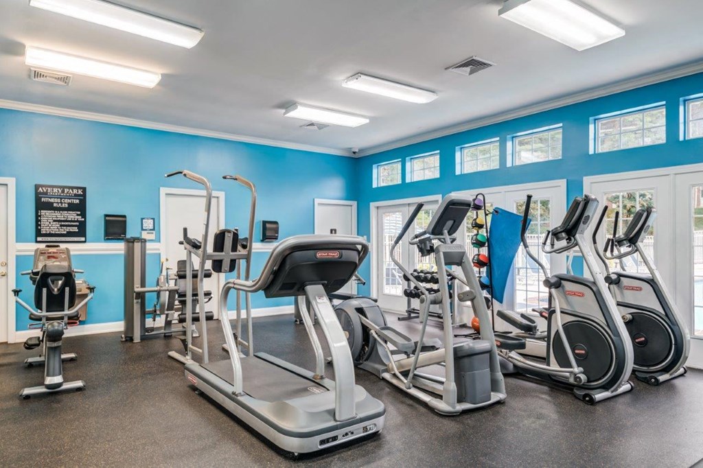 A gym with treadmills, elliptical machines, and other cardio equipment.