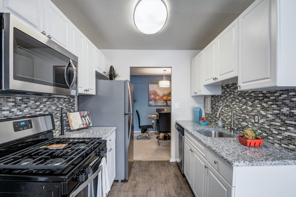 a kitchen with stainless steel appliances and granite counter tops