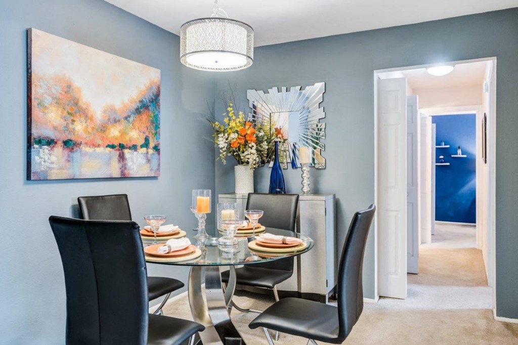 a dining room with a table and chairs
