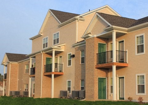 a row of brick apartment buildings with balconies