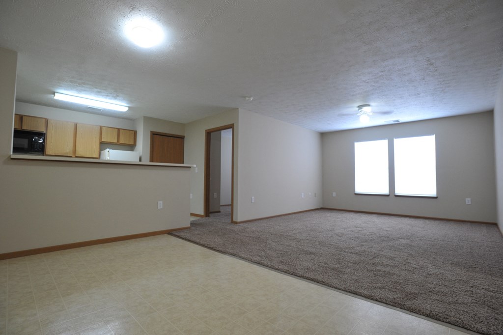 an empty living room and kitchen in a new home