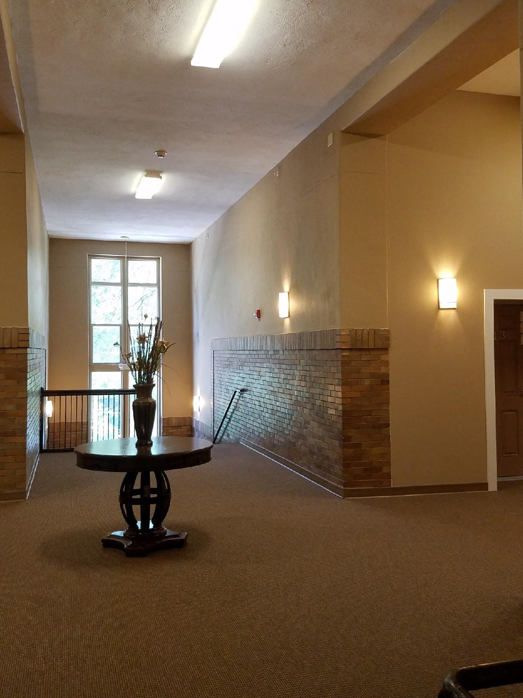 an empty living room with a table and a window