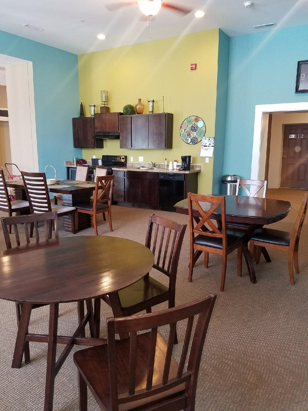 a dining room and kitchen with a table and chairs