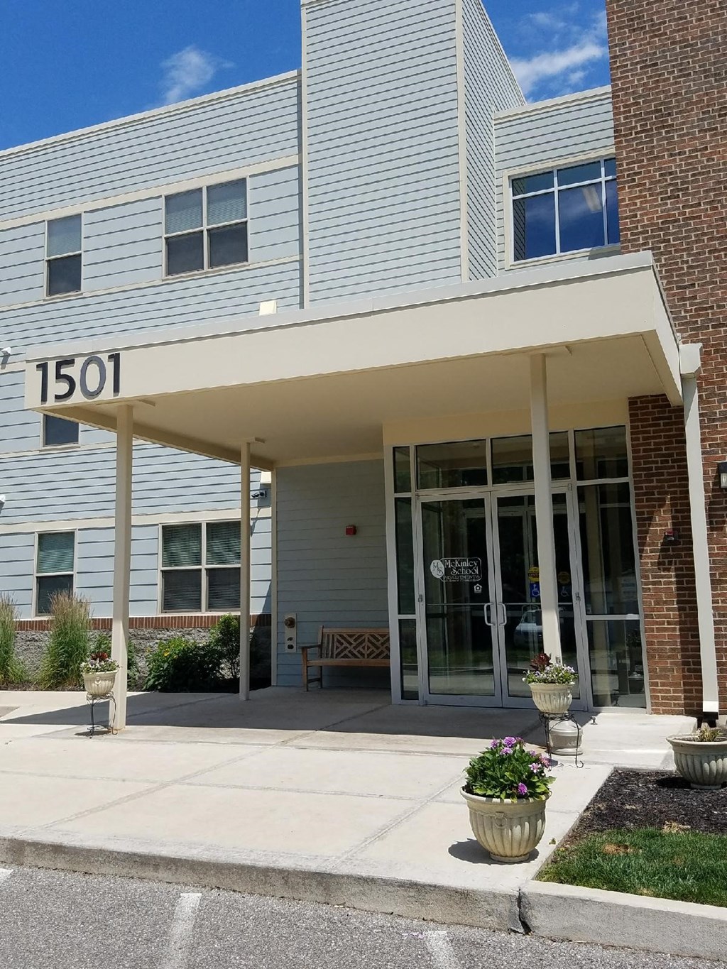 the front entrance of a building with a porch