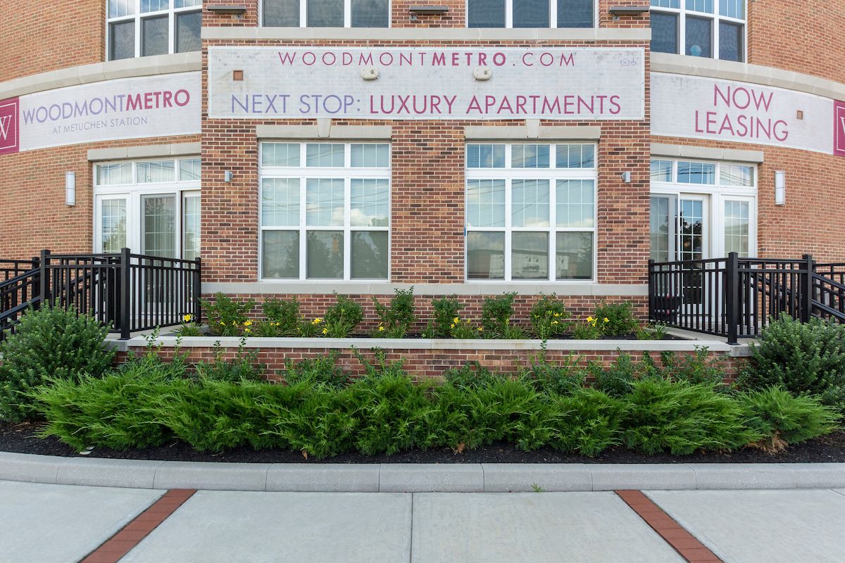 the front of a building with plants in front of it