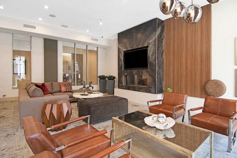 a living room with a fireplace and a table and chairs