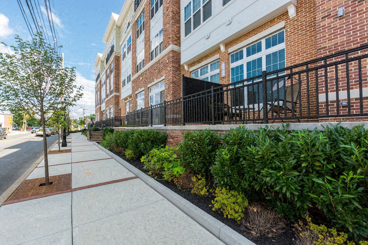 a large brick building with a sidewalk in front of it