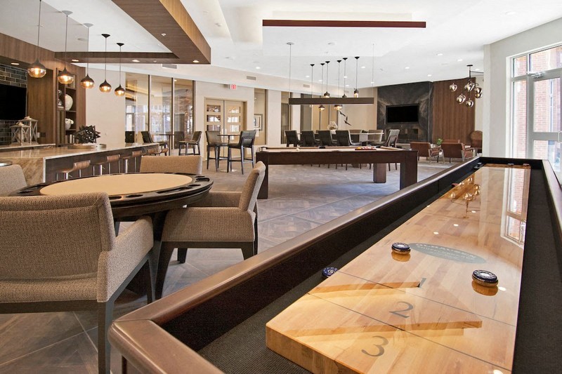 a large lobby with tables and chairs and a bar