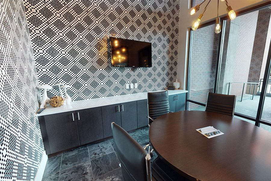 a conference room with a table and chairs and a television