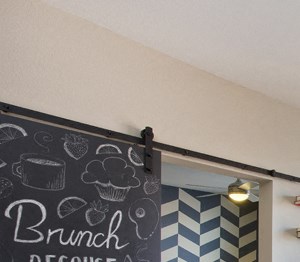 Sliding barn door The Battery on Blake Street model living room - Studios near the Ballpark, CO - Photo Gallery 3