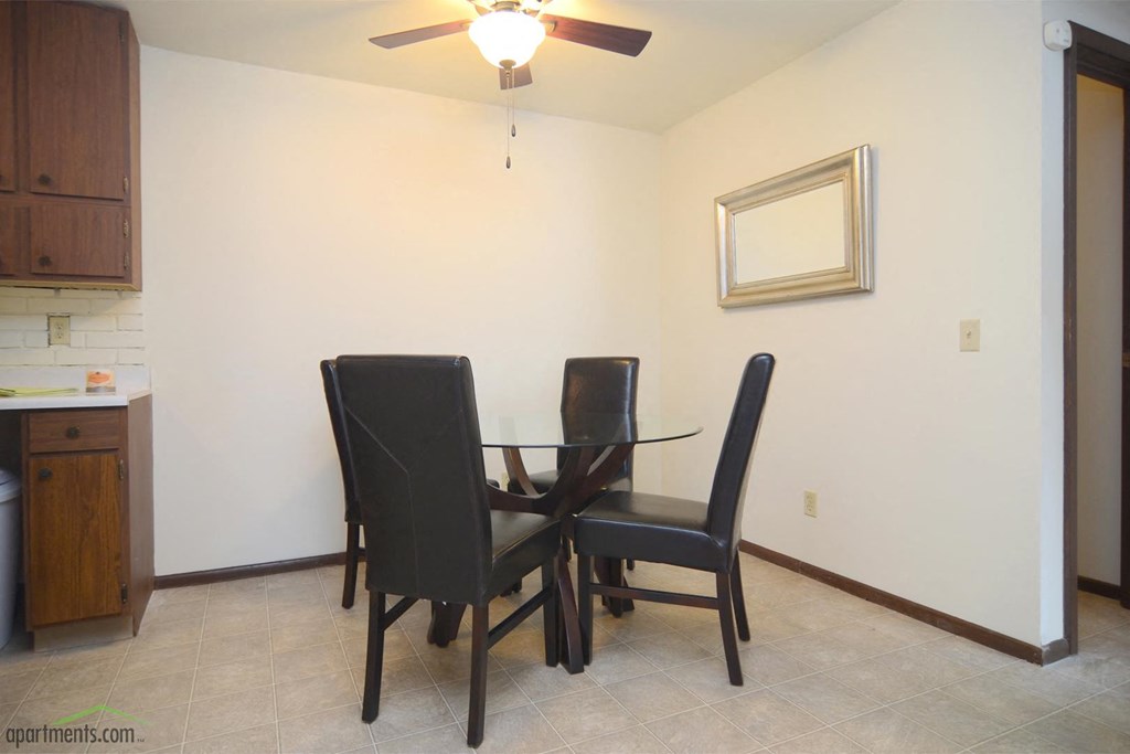 a dining room with a table and chairs