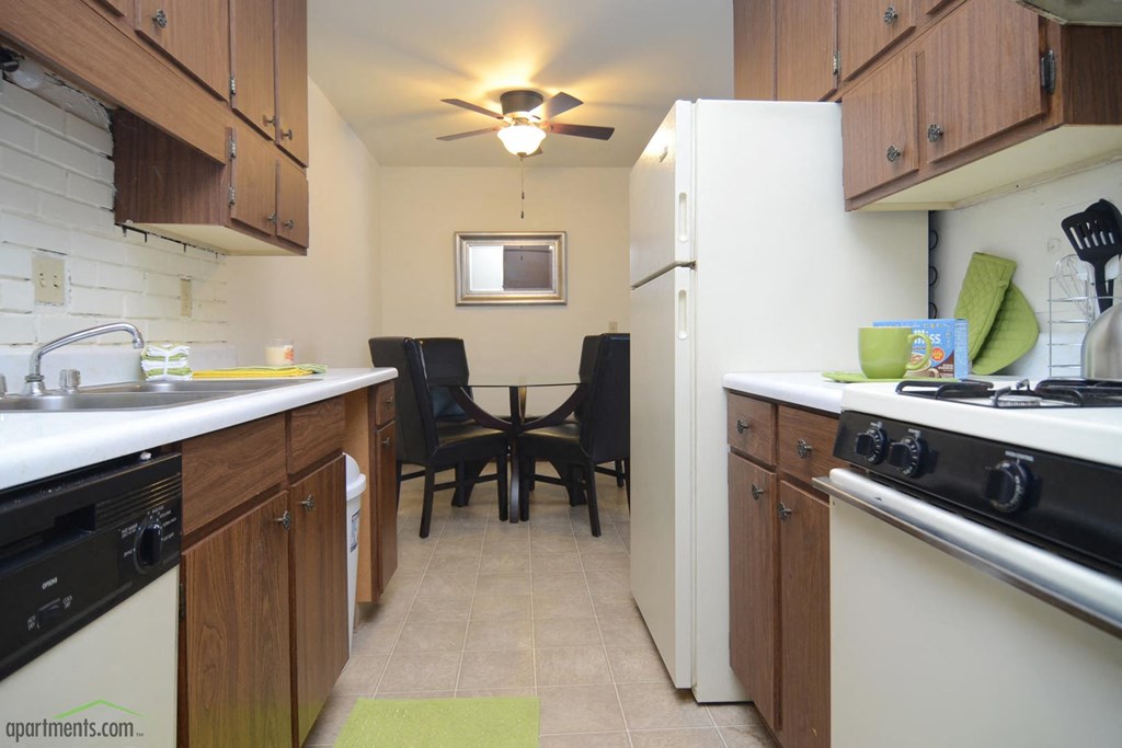 a kitchen and dining room with a table and chairs