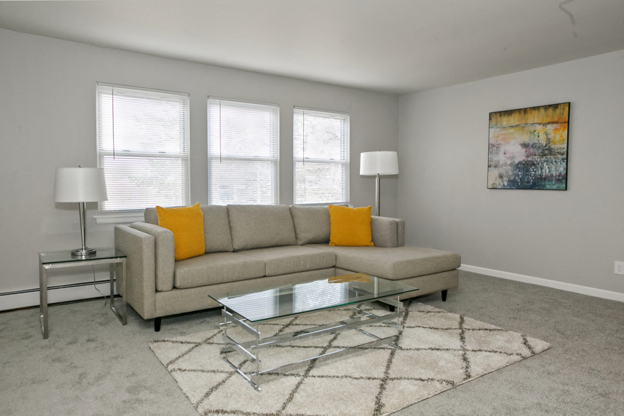 a living room with a couch and a glass coffee table