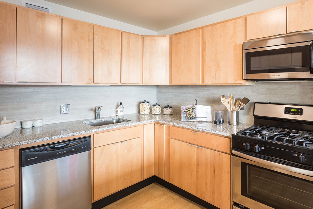 a kitchen with stainless steel appliances and wooden cabinets