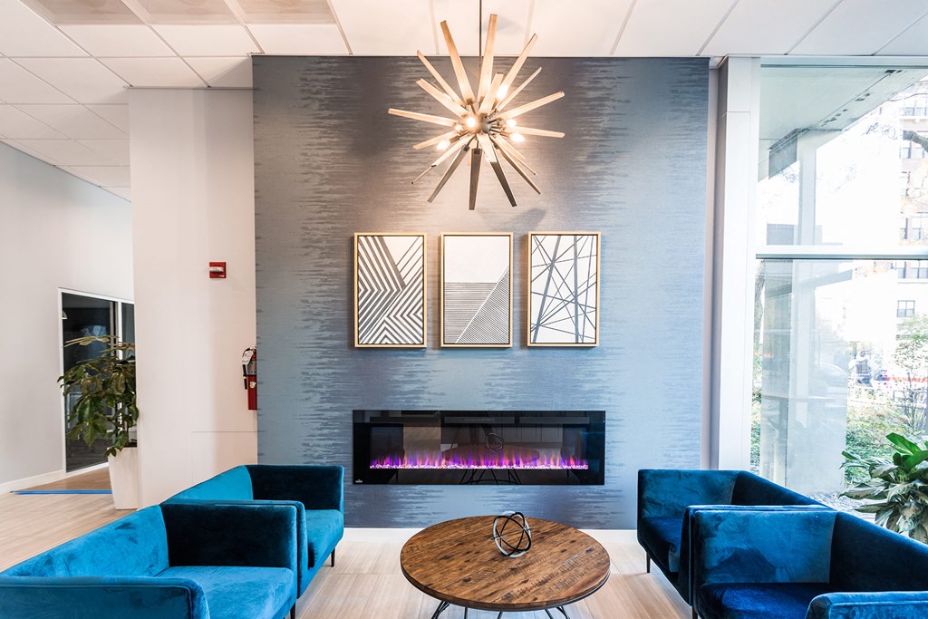 a living room with blue furniture and a fireplace