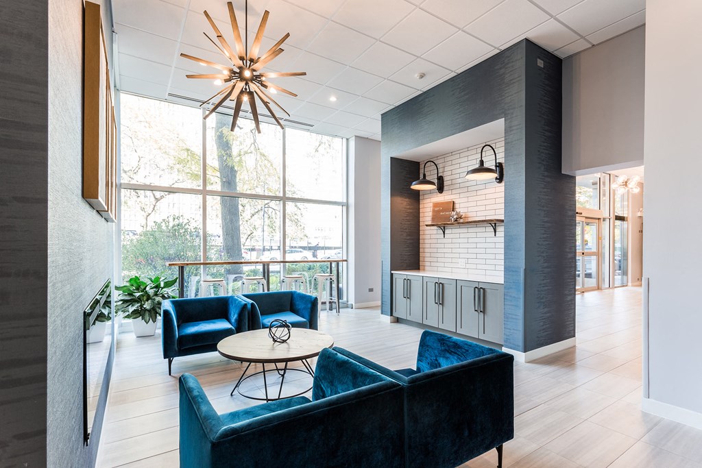 a living room with blue couches and a table