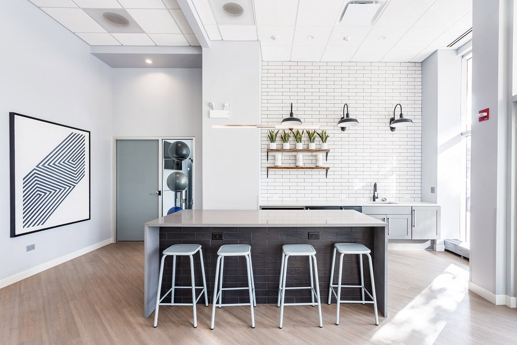 a kitchen with a large island and three stools