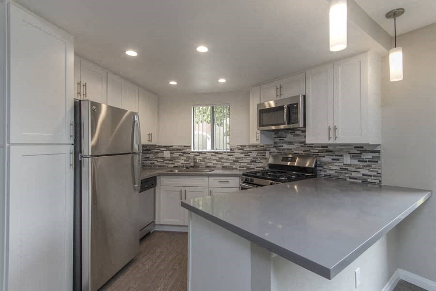 a kitchen with a counter top and a refrigerator
