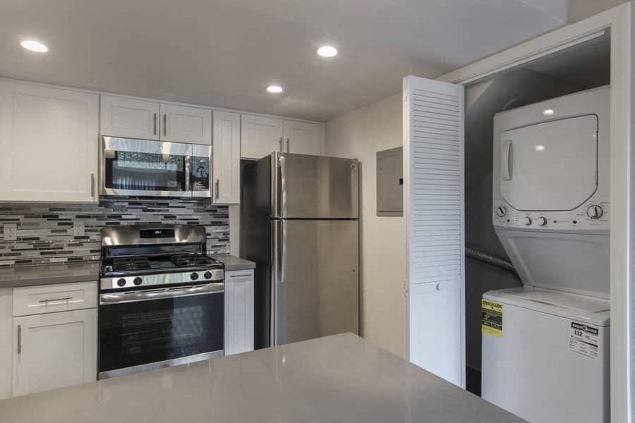 a kitchen with stainless steel appliances and a refrigerator