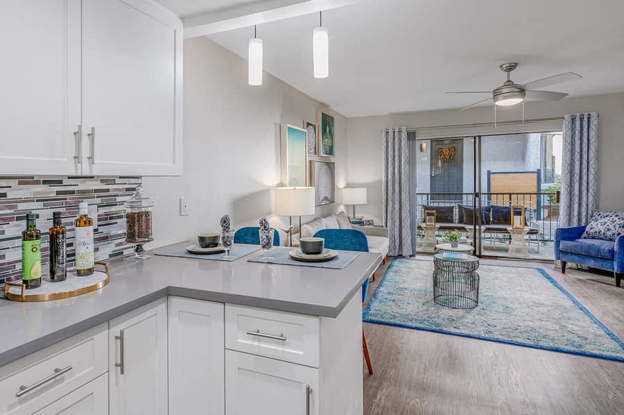 a kitchen with a view of a living room