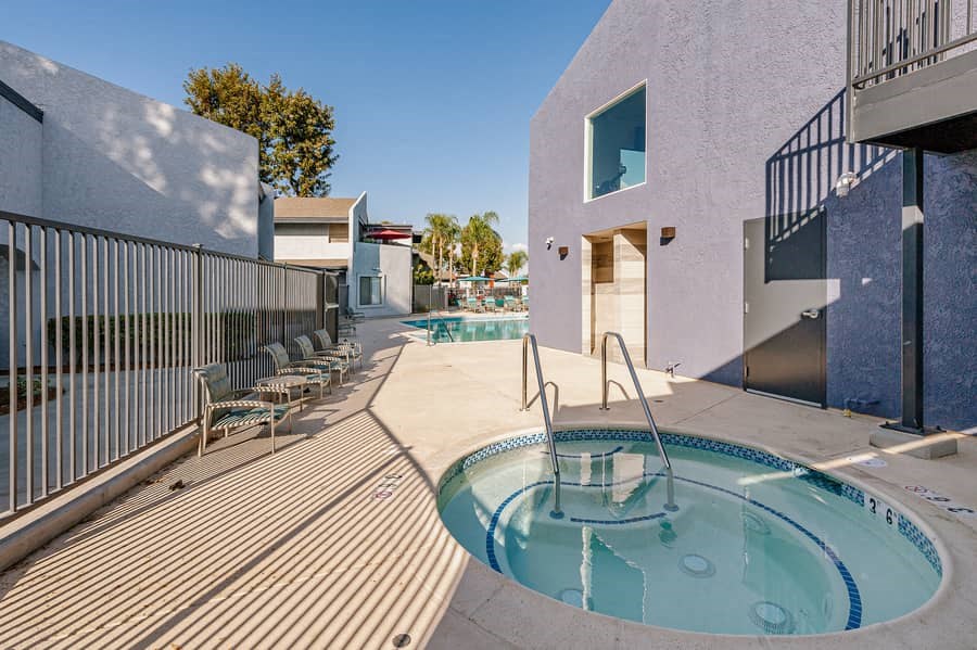 a hot tub and pool on a patio next to a building
