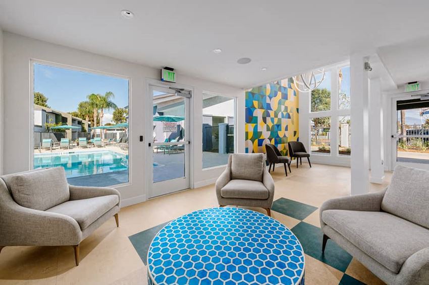 a living room with a pool and a blue table