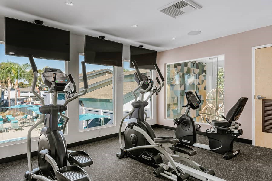 a gym with a view of a swimming pool