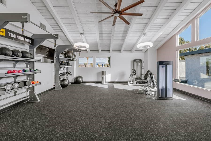 the gym has plenty of equipment and a large window