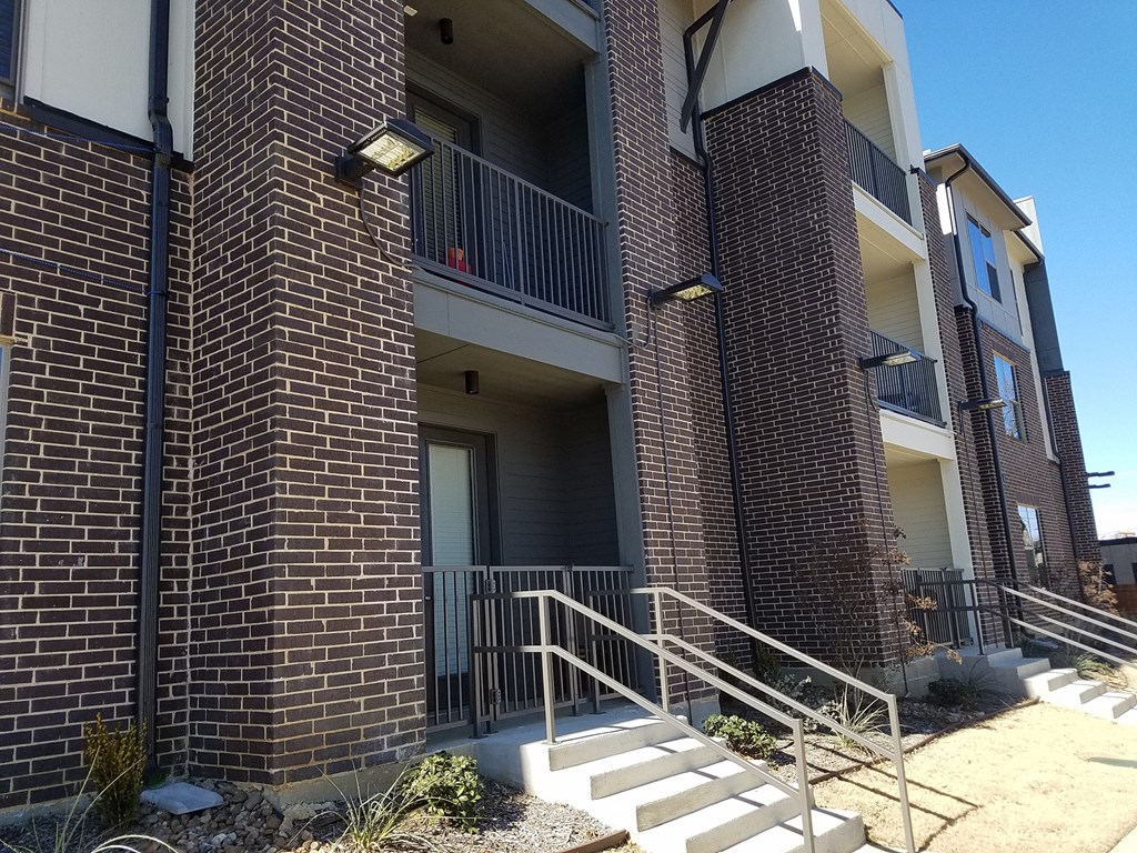 an apartment building with stairs in front of it