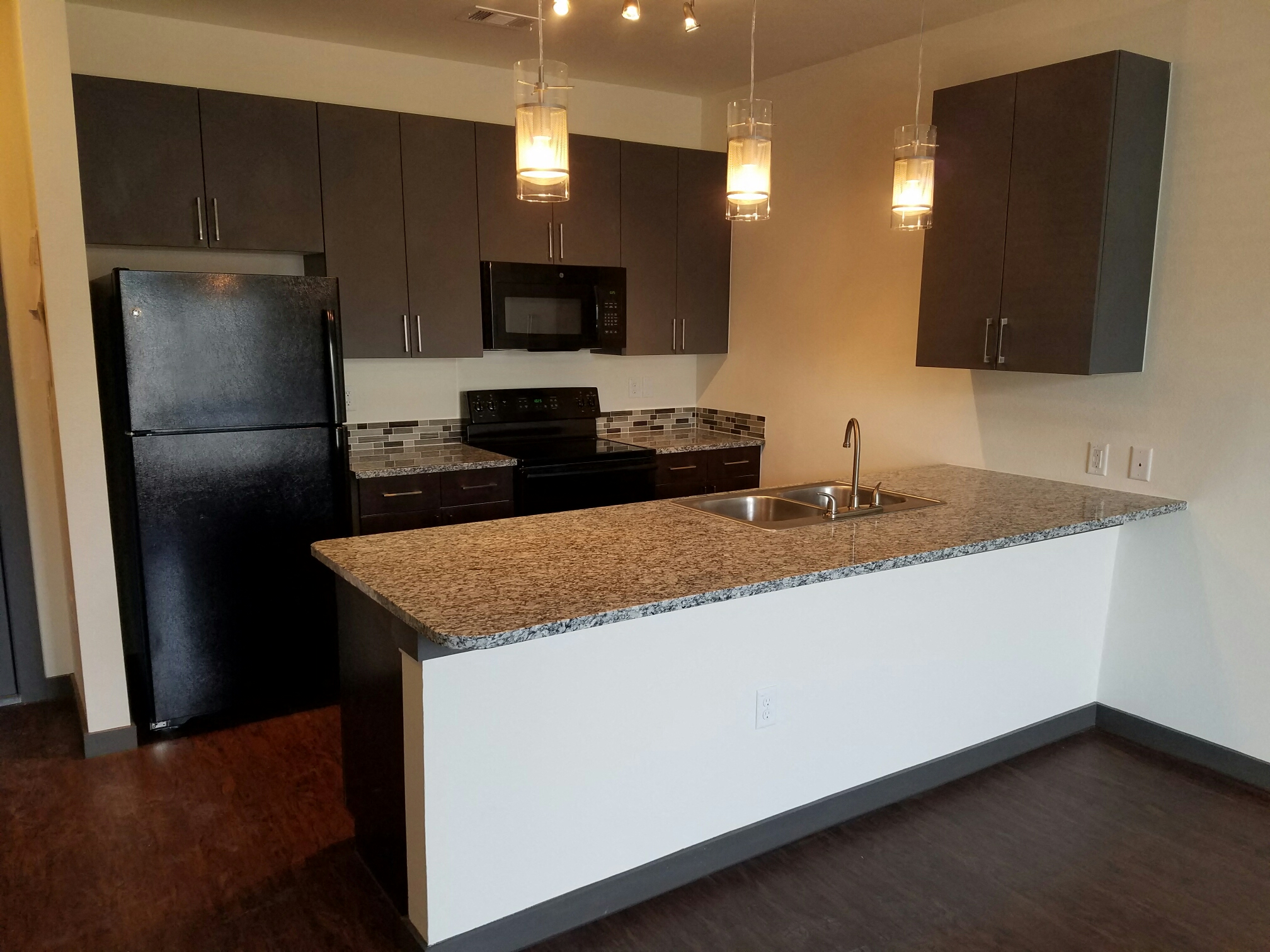 a kitchen with black appliances and granite counter tops