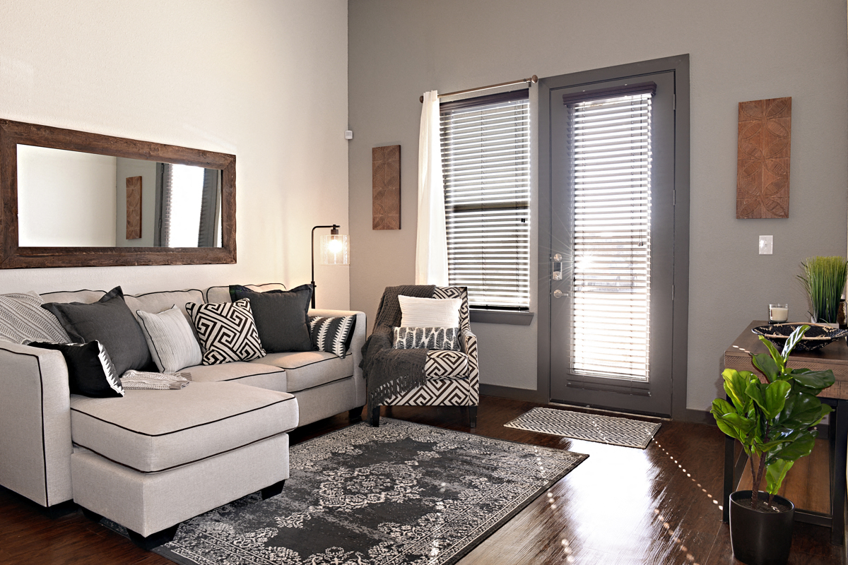 a living room with a couch and a chair and a door