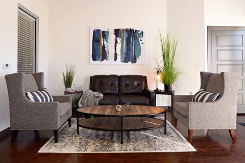 a living room with a couch and chairs and a coffee table