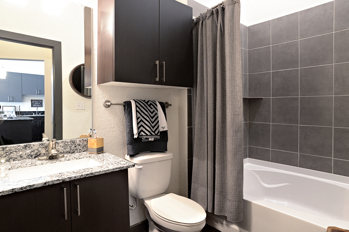 a bathroom with a shower toilet and sink and a tub