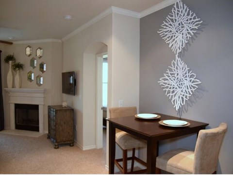 a dining room with a table and chairs