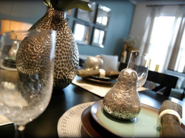 a table with a vase and some glasses on it