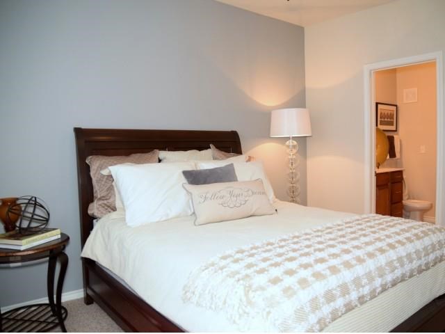 a bedroom with a large bed with pillows on it