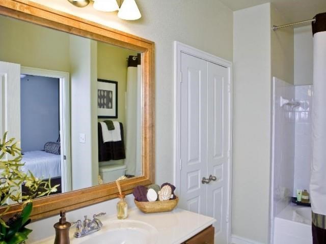 a bathroom with a large mirror and a sink