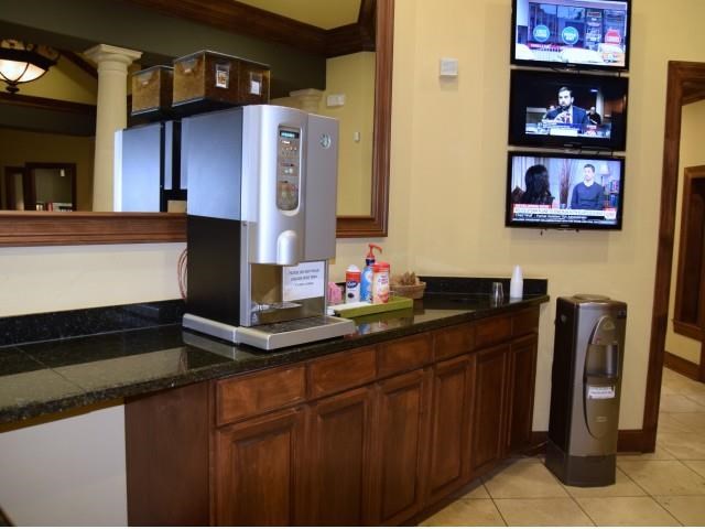 a coffee maker sitting on a counter in a hotel lobby